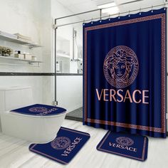 a blue shower curtain with the versa logo on it and two matching rugs in front