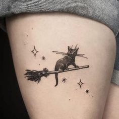 a black and white image of a rat on a broom tattoo design by person with stars