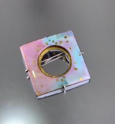 Modern opalescent kiln fired enamel with 24K gold in shades of blue, violet, golden pink and rose. Set into a sterling silver and 24K gold keum-boo back. Custom modified C clasp closure, 1.5" X 1.5". *please use contact form to request additional information or photos, thanks! Luxury Silver Enamel Brooches, Luxury Enamel Wedding Brooches, Luxury Enamel Cabochon Jewelry, Luxury Enamel Brooch Jewelry, Luxury Enamel Brooch As A Gift, Luxury Cabochon Enamel Jewelry, Luxury Silver Enamel Jewelry, Luxury Fusion Enamel Jewelry, Luxury Handmade Enamel Brooches