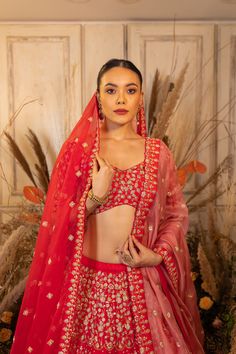 Arzoo features a fuschia reddish-pink raw silk floral and geometric patterned lehenga with a matching blouse and organza dupatta.by Chamee and Palak. DELIVERY TIMEPlease allow 4-6 months for your outfit to arrive. FABRIC DETAILSRaw silk, Organza