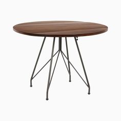 a round wooden table with metal legs