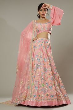 Candy floss pink raw silk lehenga with attached cancan, featuring hand embroidered floral puzzle patterns with cutdana and colorful sequins. Comes with embroidered padded blouse and dupatta.
Component: 3
Pattern: Hand Embroidered
Type Of Work: Floral Pattern, Sequins Cutdana
Neckline: Sweetheart
Sleeve Type: Puff Sleeve
Fabric: Raw Silk, Silk Organza
Color: Pink
Other Details: 
Floral patters
Embroidered cuffs
Back sheer panel
Approximate product weight: 4.5-5 Kg
Occasion: Bride, Wedding - Aza F Pink Raw Silk Set With Zari Work, Pink Raw Silk Traditional Wear With Resham Embroidery, Pink Traditional Wear With Resham Embroidery, Pink Art Silk Choli With Zari Work, Pink Dori Work Sets For Eid, Pink Silk Traditional Wear For Reception, Festive Pink Raw Silk Traditional Wear, Pink Dola Silk Choli With Zari Work, Pink Dola Silk Sets With Gota Work