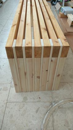 a wooden bench sitting on top of a tiled floor