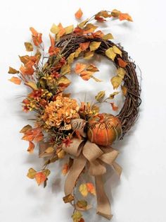 an autumn wreath with pumpkins and leaves