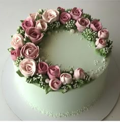 a white cake with pink and green flowers on top