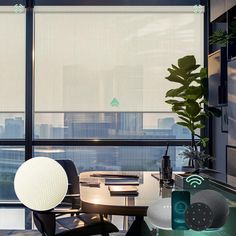 an office with large windows and a view of the city from it's desk