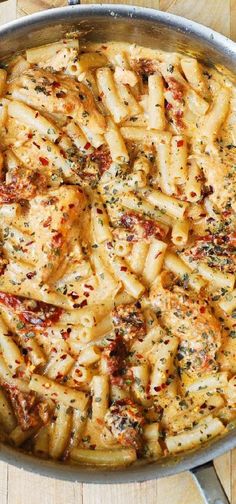 a pan filled with pasta covered in sauce and seasoning