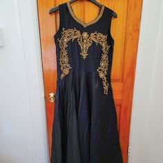 Beautiful Dark Navy Blue With Gold Embroidery Work On The Next Line. Brand New Without Tag. Traditional Embroidered Maxi Dress For Reception, Elegant Dress With Tonal Embroidery For Festive Occasions, Elegant Festive Dress With Tonal Embroidery, Elegant Floor-length Embroidered Fabric With Gold Details, Elegant Floor-length Embroidered Fabric With Gold Embroidery, Elegant Floor-length Gold Embroidered Fabric, Formal Festive Maxi Dress With Floral Embroidery, Blue Dress With Gold Embroidery For Wedding, Embroidered Fitted Long Gown