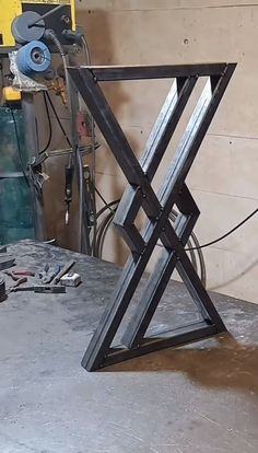 a piece of metal sitting on top of a table in a room filled with tools