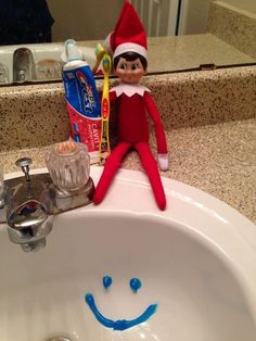 an elf is sitting in the sink with toothpaste