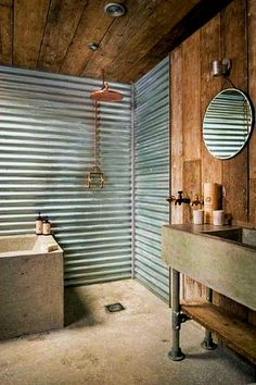 a bathroom with a sink, mirror and bathtub next to a corrugated wall behind it