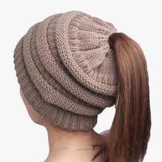 a woman's ponytail wearing a knitted hat