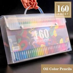 a person holding a clear plastic box with colored pencils in it and the words oil color pencils on top