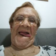 an older woman with glasses making a funny face