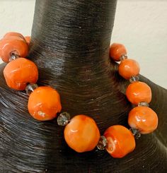 This gorgeous bold, chunky and heavy orange polished coral necklace is stunning alone or worn layered with other pieces such as Chrysocolla, Turquoise, Pearls, Copper or Sterling and even other red corals. Each bead measures approximately 1.25" and is separated from the others by a large faceted crystal and individual knots. Non-adjustable at 23" with a black toggle gemstone clasp. This is a dense piece which I do NOT consider heavy, however, for anyone with neck or back issues this might pose a challenge as you could fatigue over time. OOAK Wearable Art from the Atelier of Kat Kouture! Unique Orange Gemstone Beads, Unique Orange Necklace With Polished Beads, Unique Orange Gemstone Bead Necklaces, Unique Polished Orange Beads, Unique Orange Necklace With Large Beads, Unique Orange Round Bead Necklaces, Unique Orange Beaded Necklaces, Unique Orange Necklaces With Round Beads, Beaded Statement Necklace