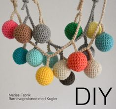 a crocheted multicolored ball ornament hanging from a string with the words diy written below it