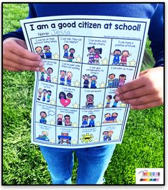 a person holding up a poster that says i am a good citizen at school