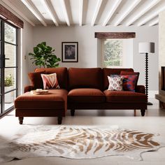 a living room filled with furniture and a large window covered in white beams on the ceiling