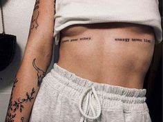 two women with tattoos on their stomachs and one has the words energy never lies