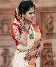 a woman in a white and red sari