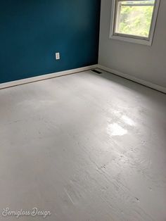 an empty room with blue walls and white paint on the floor is pictured in this image