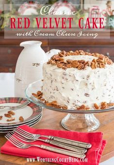 a red velvet cake with cream cheese frosting and pecans is on a table