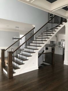 an open floor plan with stairs leading up to the kitchen