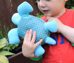 a young boy holding a stuffed animal in his hands