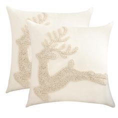 two white pillows with decorative designs on them