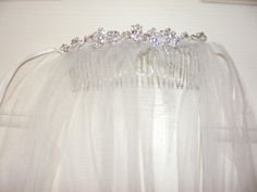 a bridal hair comb with crystal stones on the headband and tulle veil