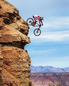 a person on a bike jumping over a cliff