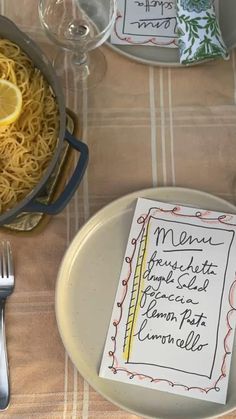 a table set with plates, silverware and menus for a dinner or party