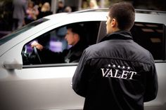 a male in a black jacket and some cars