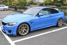 a blue car parked in a parking lot