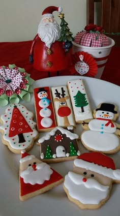 decorated christmas cookies on a plate with santa clause