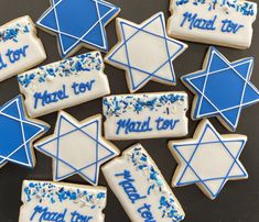 decorated cookies with blue and white icing are arranged in the shape of star of david