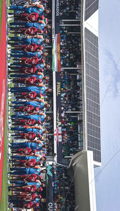 a large group of people standing next to each other in front of a tall building