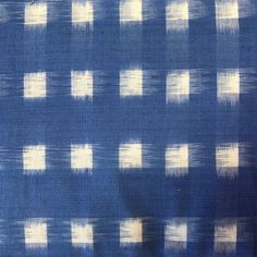 a blue and white fabric with squares on it