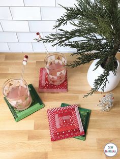 three coasters on a wooden table with a potted plant in the corner and other decorations