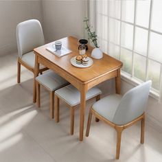 a wooden table with four white chairs around it