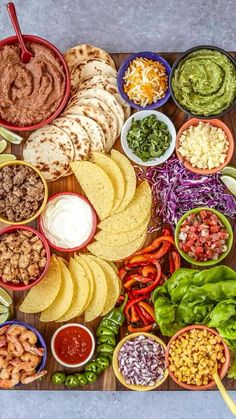 a platter filled with tacos, tortillas and salsa