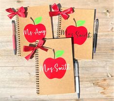 three personalized notebooks with red bows and apple designs on them, one is for mr and mrs smith