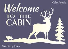 welcome to the cabin sign with deer and tree silhouettes on purple background, white lettering reads welcome to the cabin