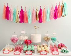 the dessert table is decorated with colorful tassels