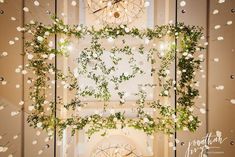 an overhead view of flowers and greenery in a room with a chandelier