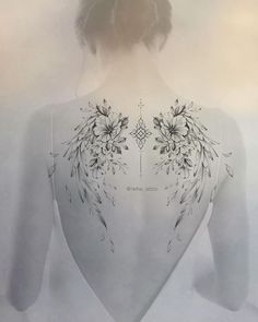 the back of a woman's body with flowers on it