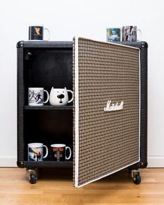 a black and white cabinet with coffee mugs on it