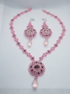 "This stylish set includes matching  pendant and earrings featuring pear shaped dazzling natural pink bicone and preciosa seeds beads, This 16\" long necklace 3\" earrings looks fubolas around your neck,  Wonderful shiny pink crystal bicone and seeds beads, and silver plated flowers stud and lobster claws clasp  Wonderful elegance simple design and the perfect length for showing off a -V- neck and to highlight the face. I hope my hand made necklace set complete with your favourite evening dresse Pink Round Beads Jewelry Sets For Party, Pink Jewelry Sets With Round Beads For Parties, Handmade Pink Crystal Beaded Necklaces, Pink Beaded Teardrop Jewelry, Pink Dangle Jewelry With Faceted Beads, Pink Teardrop Beaded Jewelry, Teardrop Crystal Jewelry With Dangling Beads, Teardrop Shaped Crystal Jewelry With Dangling Beads, Handmade Pink Crystal Jewelry