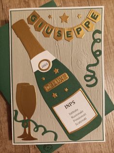 a card with a bottle of champagne and a wine glass on the front that reads, giusiepre inds