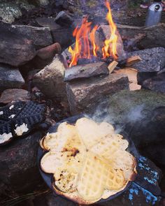 some waffles are on a plate near a campfire